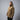 Tan hooded rain shell jacket worn by a model, standing side profile