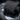 Black pouch close-up of front grommet and rounded pocket edge.