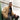 Khaki wool-lined bomber jacket worn with ribbed collar, front zipper, and side pockets