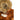 Russet shearling hood with drawstring and snap strap, fur interior and suede collar