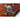 Replica flintlock pirate pistol skull emblem on brown wood stock, close-up.