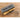 Blue goggles case with Dienst-Brille text and wire-frame eyeglasses on wood