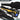 Rifle case open showing black foam inserts with yellow equipment tray and components