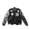 Black varsity leather jacket with ribbed collar, snap front, and embroidered patches
