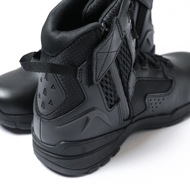Black tactical boots showing treaded sole and rear ankle padding