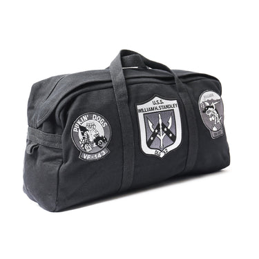 Black duffel bag with top handle, side zipper panel, and three embroidered mission patches
