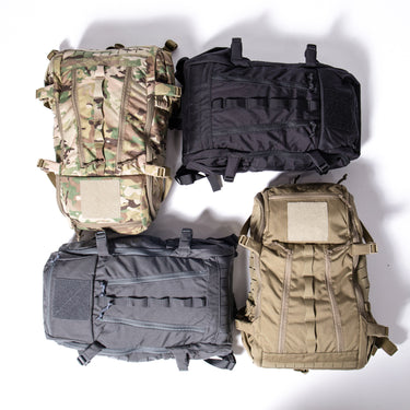 Assorted tactical backpacks in camouflage and solid colors, shown together