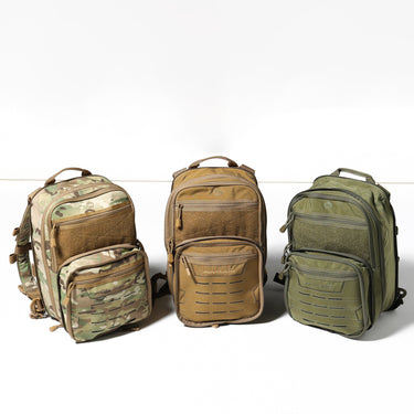 Three quick backpacks in camo, tan, and olive green with front pockets and zippers
