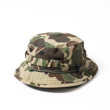Boonie hat in woodland camouflage with mesh-like brim and side grommet details
