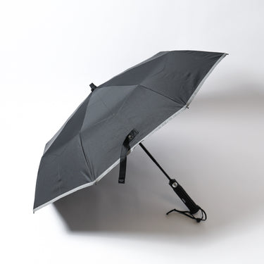 Tactical collapsible umbrella with dark gray canopy, open frame and push-button strap