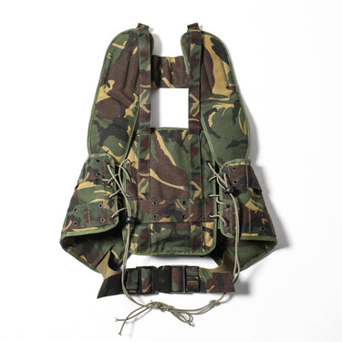 Camouflage load-bearing vest back panel with belt webbing, grommets, and cord ties
