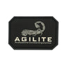 Black octagonal logo patch with stitched edge and beige Agilite emblem
