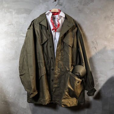 Olive drab combat parka with open front, stand collar, and multiple utility pockets.