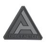 Black triangular rubber logo patch with Direct Action lettering