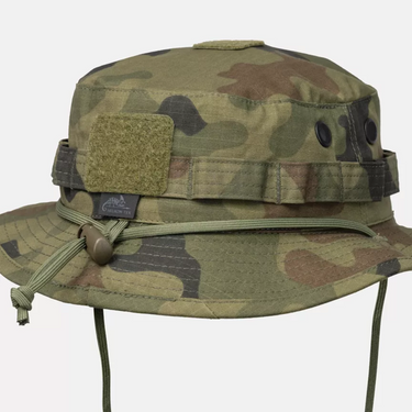 Camouflage boonie hat with a hook-and-loop patch, ventilation eyelets, and adjustable chin cord