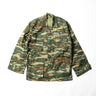 Camouflage field jacket with button front, flap chest pockets, and stand collar