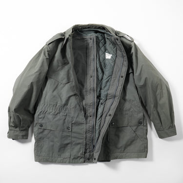 Grey coat with hood, zip front, flap pockets, and draped quilted inner lining