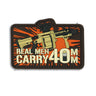 40mm tactical PVC patch with rifle, handgun, orange burst and 'Real Men Carry' text