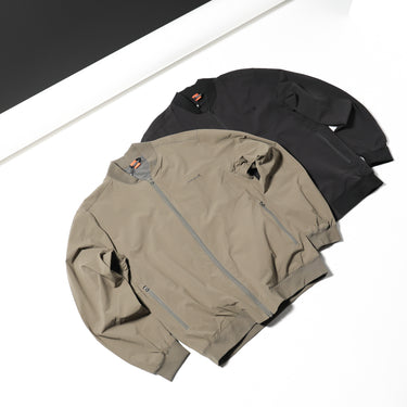 Flight jacket in black and tan, full front zipper with ribbed cuffs and hem.