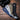 Lightweight merino socks in navy, grey, olive, and black, each with a hex logo on top.