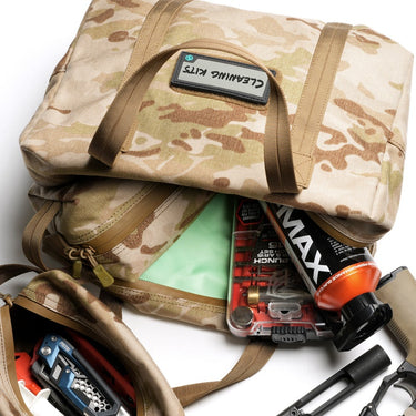 Camouflage mini hauler with tan straps, open top showing mint-green insert and gear