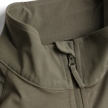 Close-up of green quarter-zip collar with zipper pull and stitched placket