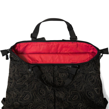 Black patterned tote bag with red interior panel and zip-top opening