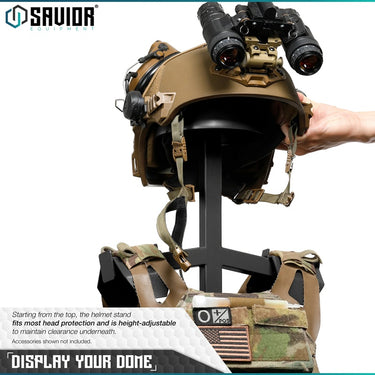 Tan tactical helmet display stand with binoculars and mounted gear straps