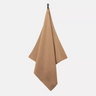 Coyote brown field towel, triangular folded fabric with metal clip at top.