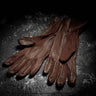 Brown leather flight gloves with cuff to knuckle design and stitched finger panels