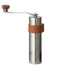 Stainless hand coffee grinder with copper accents and crank handle