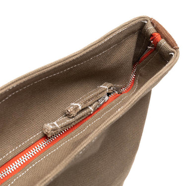 Olive tote bag interior with zippered pocket and orange-red zipper pull