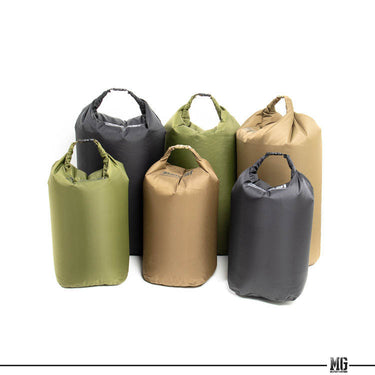 Assorted dry bag liners with loop handles, including olive drab, grey, black, and coyote
