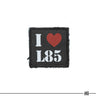 Black embroidered square patch with red heart and white “I L83” letters
