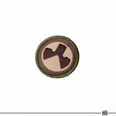 Magpul logo patch, brown-and-tan circular embroidered emblem with green edge stitching