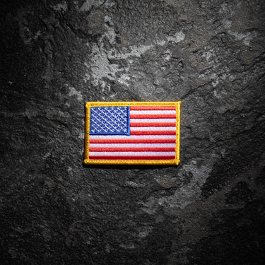 Embroidered US flag nationality badge with yellow edging, blue canton left