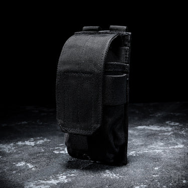 Black single magazine pouch shown from the side with MOLLE-style webbing.