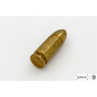Brass-colored replica bullet lying on its side, rounded nose and base